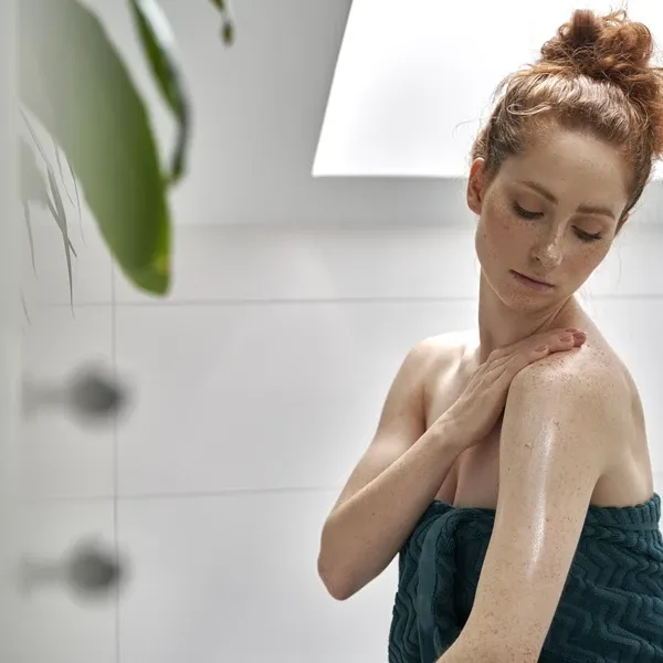 Woman sitting in bathroom after shower