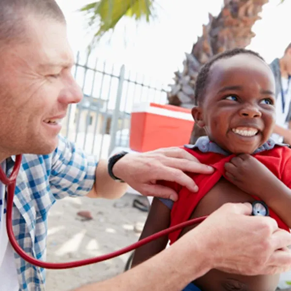 A doctor in Africa with a kid